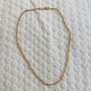 Gold tone twisted look necklace. New in bag